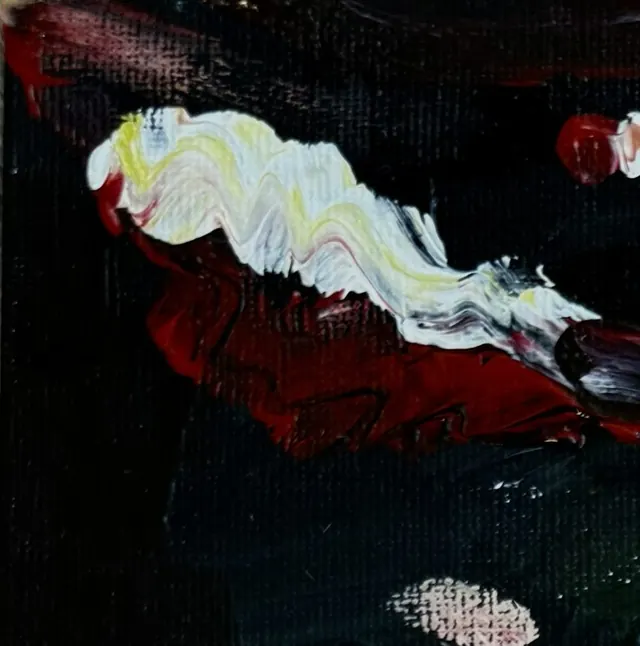 A white and yellow ribbon of paint over deep red